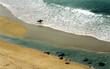a lone surfer approches the sea