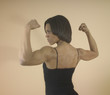 strong woman flexing her arm muscles