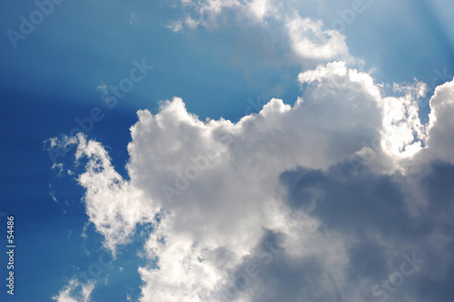bright blue sky with backlit cloud