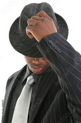 Photo: attractive young man in pinstripe suit tipping his attractive young man in pinstripe suit tipping his