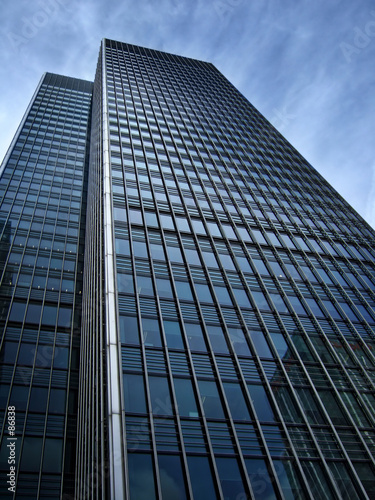 dark looming office blocks in canary wharf, london.