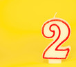 number two candle on yellow background number two candle on yellow background