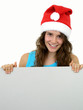 Photo: girl wearing christmas hat holding white card girl wearing christmas hat holding white card