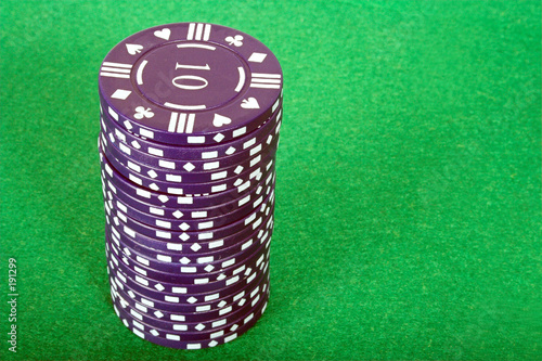Photo: blue pile of casino chips over green blue pile of casino chips over green