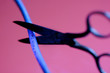 sissors cutting a blue cable