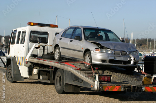accident damaged car on trailer