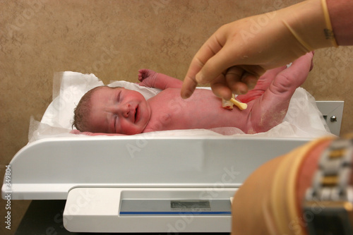 new born baby being weighed