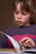 young girl reading a book