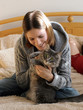 Photo: happy girl playing with her kitten happy girl playing with her kitten