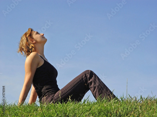 beautiful woman sitting in the grass