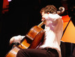 man playing cello at the concert