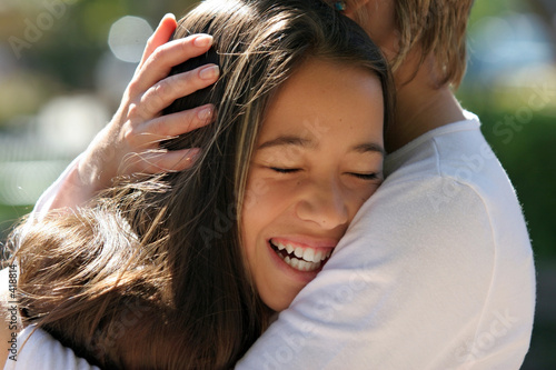 Photo: mother hugging her happy daughter mother hugging her happy daughter