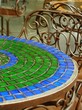 mosaic tabletops and metal chairs