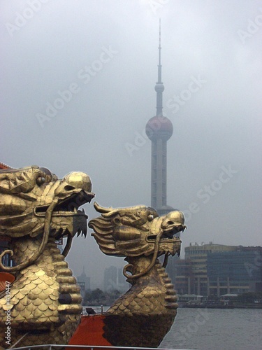 dragon in front of the orientel pearl tower dragon in front of the orientel pearl tower