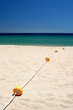 string of buoys or beach markers on sunny hot tarifa beach in so string of buoys or beach markers on sunny hot tarifa beach in so