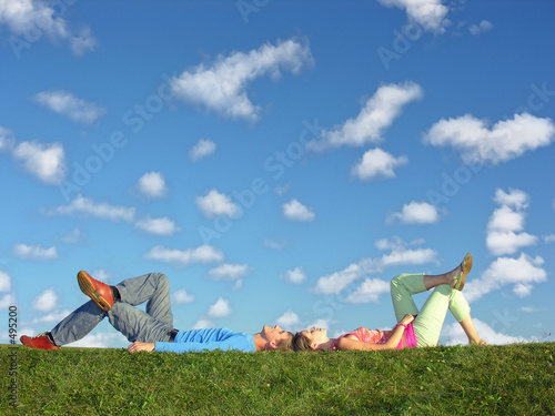 couple lies under clouds