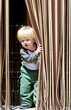 young boy with blond or blonde hair and blue eyes looking out fr