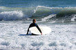 surfer walk walking out to sea to catch a big wave