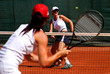 two young sporty female tennis players having a game in the sun. two young sporty female tennis players having a game in the sun.