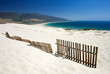 Photo: old fence sticking out of deserted sandy beach dunes old fence sticking out of deserted sandy beach dunes