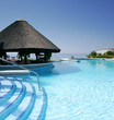 tiki hut and bar by swimming pool of luxury hotel