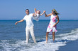young family playing with daughter on beach in spain young family playing with daughter on beach in spain