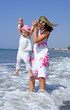 young mother and daughter playing in the sea