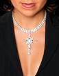 neckline and bra-less chest of young attractive girl with diamon