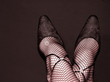 sexy feminine legs with high heel black shoes and cristal stones