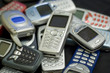 silver cellular phone on top of pile. silver cellular phone on top of pile.
