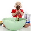 baby licking cake mixer