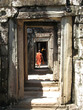 monks walk through passageways at bantaey kdei, an monks walk through passageways at bantaey kdei, an