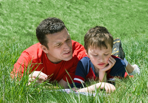 Photo: father and son reading father and son reading
