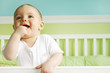 baby boy smiling in crib