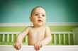 baby boy playing in crib