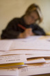 young female teacher marking exams.