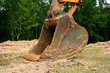 the scooping shovel on a back hoe