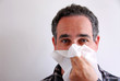 sick man blowing nose