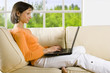 clipping path! woman with laptop on the sofa