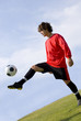 Photo: soccer - football player juggling in red soccer - football player juggling in red