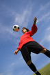 soccer football player in red controlling ball