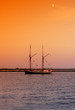 ship heading to docks after sunset