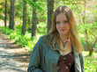 pretty young girl walking in forest garden