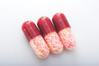 three pills on white