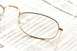 glasses on a newspaper