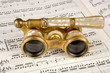 antique opera glasses on a music score