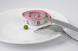 pea and measuring tape on a plate