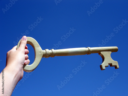 Photo: hand holding a key hand holding a key