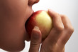 the young woman tastes a peach
