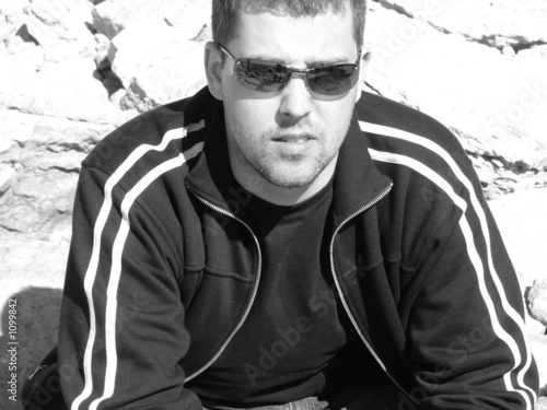 Photo: young man sitting young man sitting